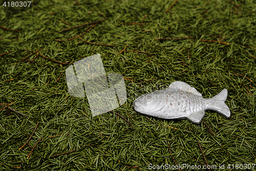 Image of Christmas background of fur-tree needles and toy fish