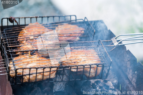 Image of Cook chicken piece with spice on frying pan