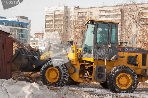 Image of Tractor on demolition of wooden houses quarter