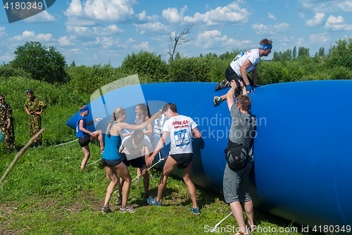 Image of Athletes overcome inflatable obstacle. Tyumen