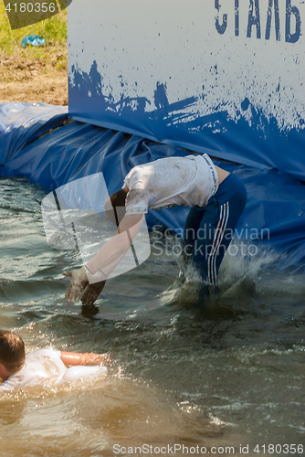 Image of Man with girl jump in water in extrim racing