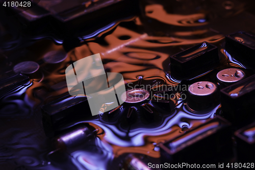 Image of vintage circuit board with dark red and blue reflection
