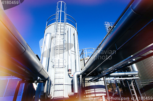 Image of Industrial zone, Steel pipelines and valves against blue sky