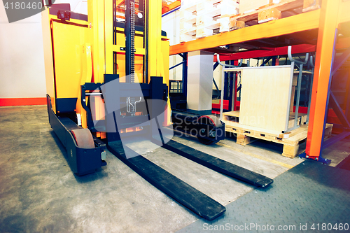 Image of Shelves, racks and forklift  with pallets in distribution wareho