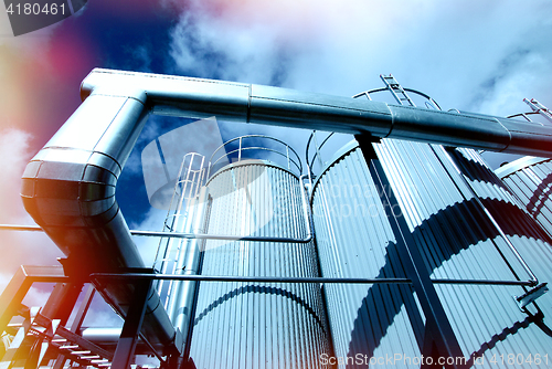 Image of Industrial zone, Steel pipelines and valves against blue sky