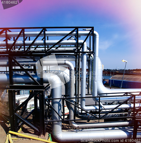 Image of Industrial zone, Steel pipelines and valves against blue sky