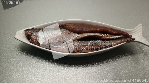 Image of  fillet salted herring with caviar on a plate