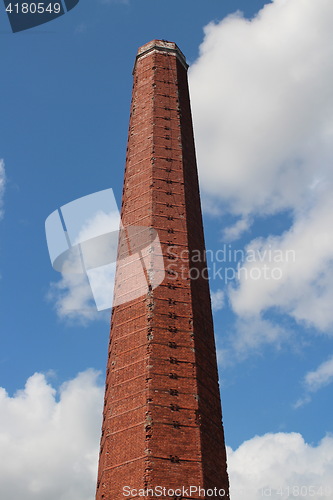 Image of  High brick smokestack in the blue sky