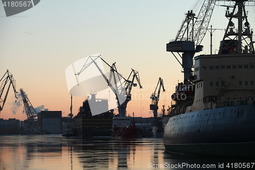 Image of  silhouettes of ships and portal cranes