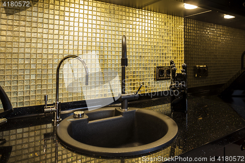 Image of Kitchen desktop with a sink and faucet