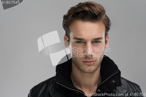 Image of portrait of a young guy over gray background