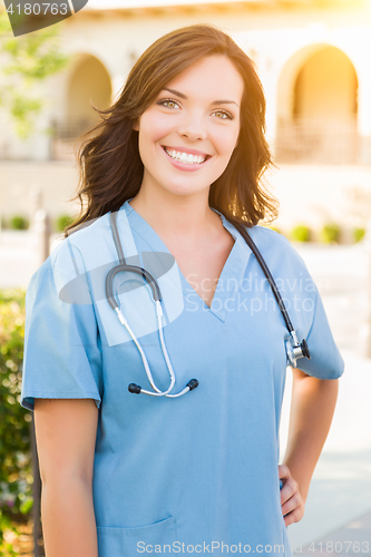 Image of Portrait of Young Adult Female Doctor or Nurse Wearing Scrubs an