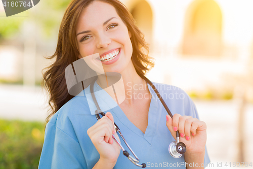 Image of Portrait of Young Adult Female Doctor or Nurse Wearing Scrubs an