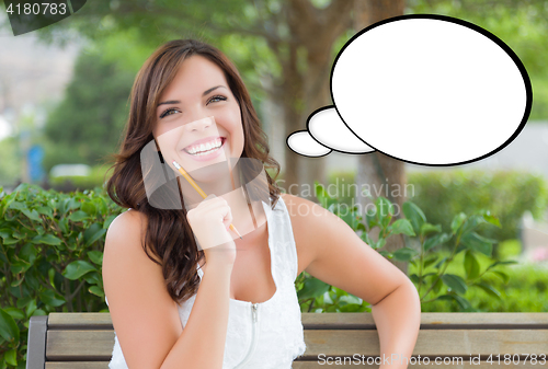 Image of Thoughtful Young Woman with Pencil and Blank Thought Bubble.