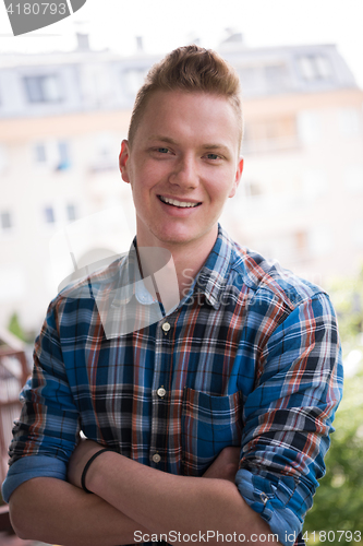 Image of man standing at balcony