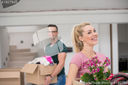 Image of young couple moving into a new home