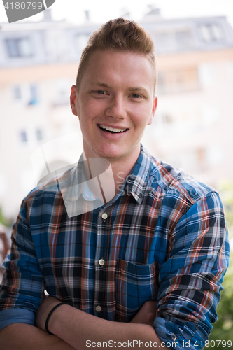 Image of man standing at balcony