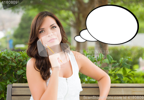 Image of Thoughtful Young Woman with Pencil and Blank Thought Bubble.