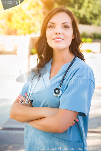 Image of Portrait of Young Adult Female Doctor or Nurse Wearing Scrubs an