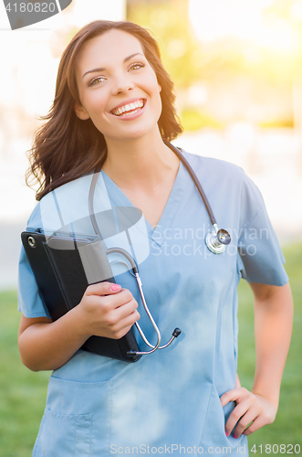 Image of Portrait of An Attractive Young Adult Woman Doctor or Nurse Hold