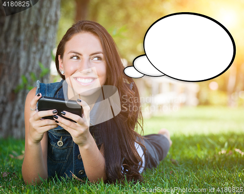 Image of Thoughtful Young Woman with Cell Phone and Blank Thought Bubble.