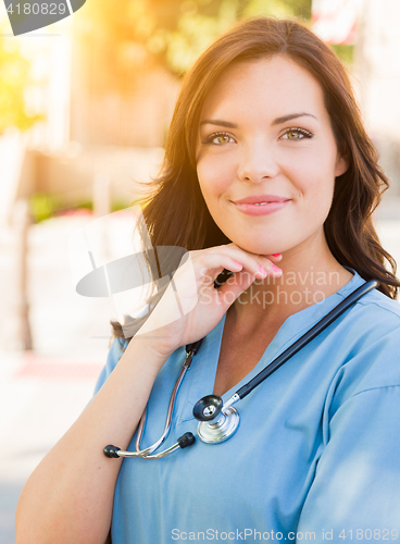 Image of Portrait of Young Adult Female Doctor or Nurse Wearing Scrubs an