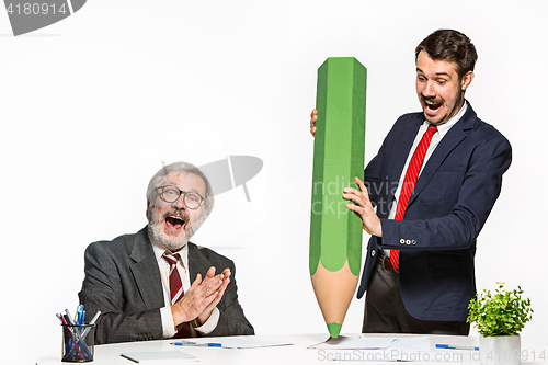 Image of The two colleagues working together at office on white background.