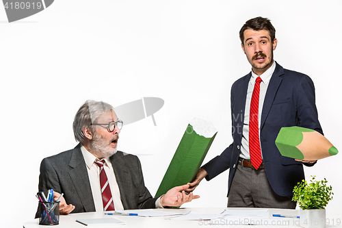 Image of The two colleagues working together at office on white background.