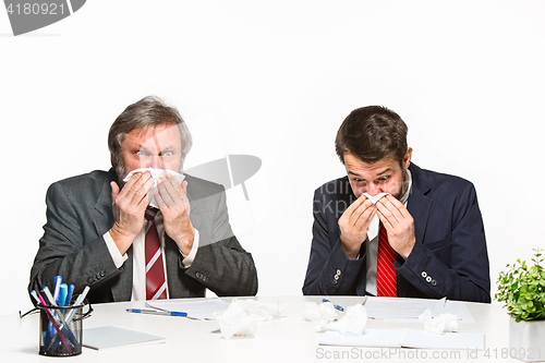 Image of The two colleagues working together at office on white background.