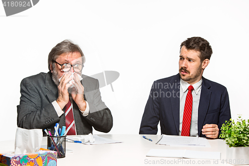 Image of The two colleagues working together at office on white background.