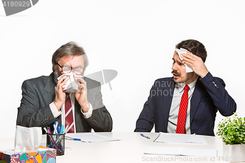 Image of The two colleagues working together at office on white background.