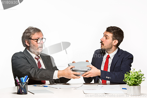 Image of The two colleagues working together at office on white background.