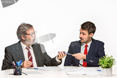 Image of The two colleagues working together at office on white background.