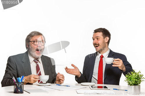 Image of The two colleagues working together at office on white background.