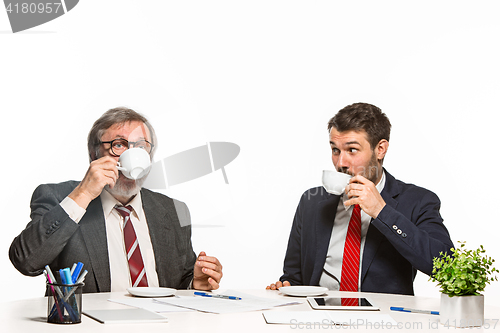 Image of The two colleagues working together at office on white background.