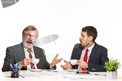 Image of The two colleagues working together at office on white background.