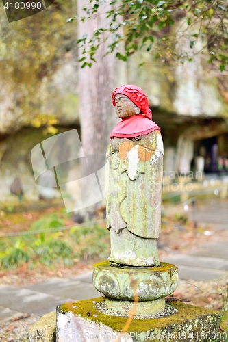 Image of Old Jizo stone statue standing in Matsushima