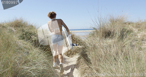 Image of Woman carrying the surfboard