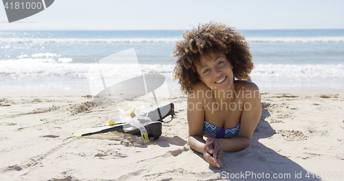 Image of Female lying on beach with flippers