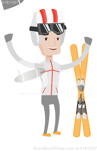 Image of Cheerful skier standing with raised hands.