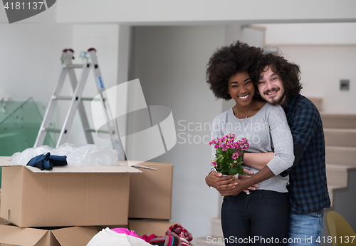 Image of multiethnic couple moving into a new home