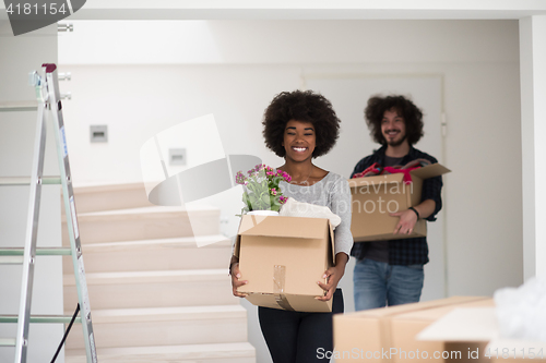 Image of multiethnic couple moving into a new home