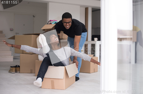 Image of African American couple  playing with packing material