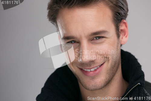 Image of portrait of a young guy over gray background