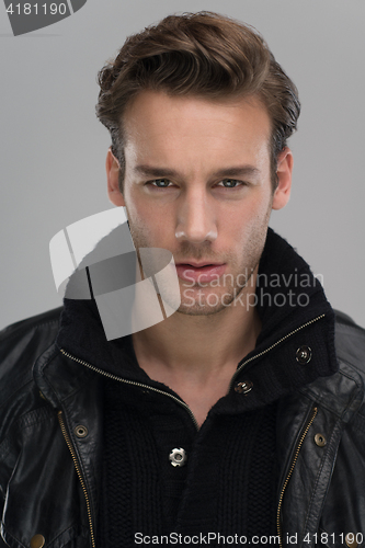 Image of portrait of a young guy over gray background