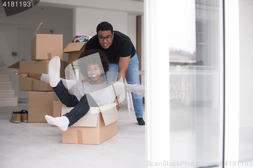 Image of African American couple  playing with packing material