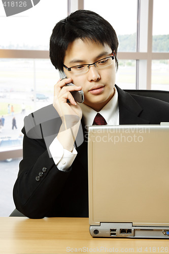 Image of Working asian businessman