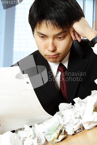 Image of Stressed asian businessman