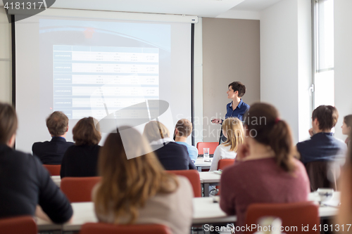 Image of Woman giving presentation in lecture hall at university.