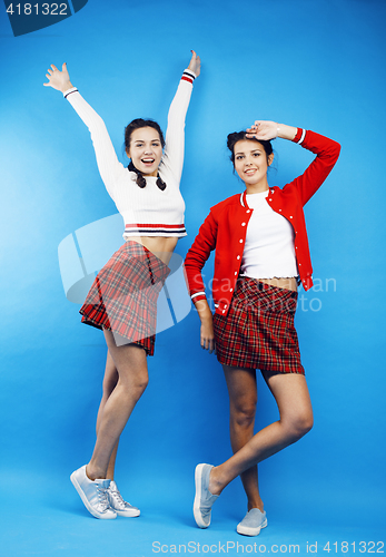 Image of best friends teenage school girls together having fun, posing emotional on blue background, besties happy smiling, lifestyle people concept 